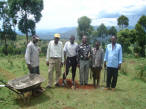 L/R in the picture:&nbsp; Shikuku, who dug the hole;&nbsp;Simeon, surveyor's helper; David, a deacon at Temso B.C.; Joseph, the surveyor; &nbsp;Joseph, surveyor's other helper; and Choge, whose property I bought.  This beacon, or marker, is at the top of the triangle at the top of the hill.&nbsp; The two sides go off to the right and left and down to the&nbsp;road which forms the bottom of the triangle.&nbsp; And, yes, it's a dirt road!&nbsp; I didn't realize how big an acre is!  Anna and her gardeners and I will be landscaping.&nbsp; Anna is a master gardener and her place is beautiful!  My children know how I pictured a beautiful garden in my backyard in Lawrenceville.&nbsp; Well, here it will be in the front yard for everyone to enjoy!